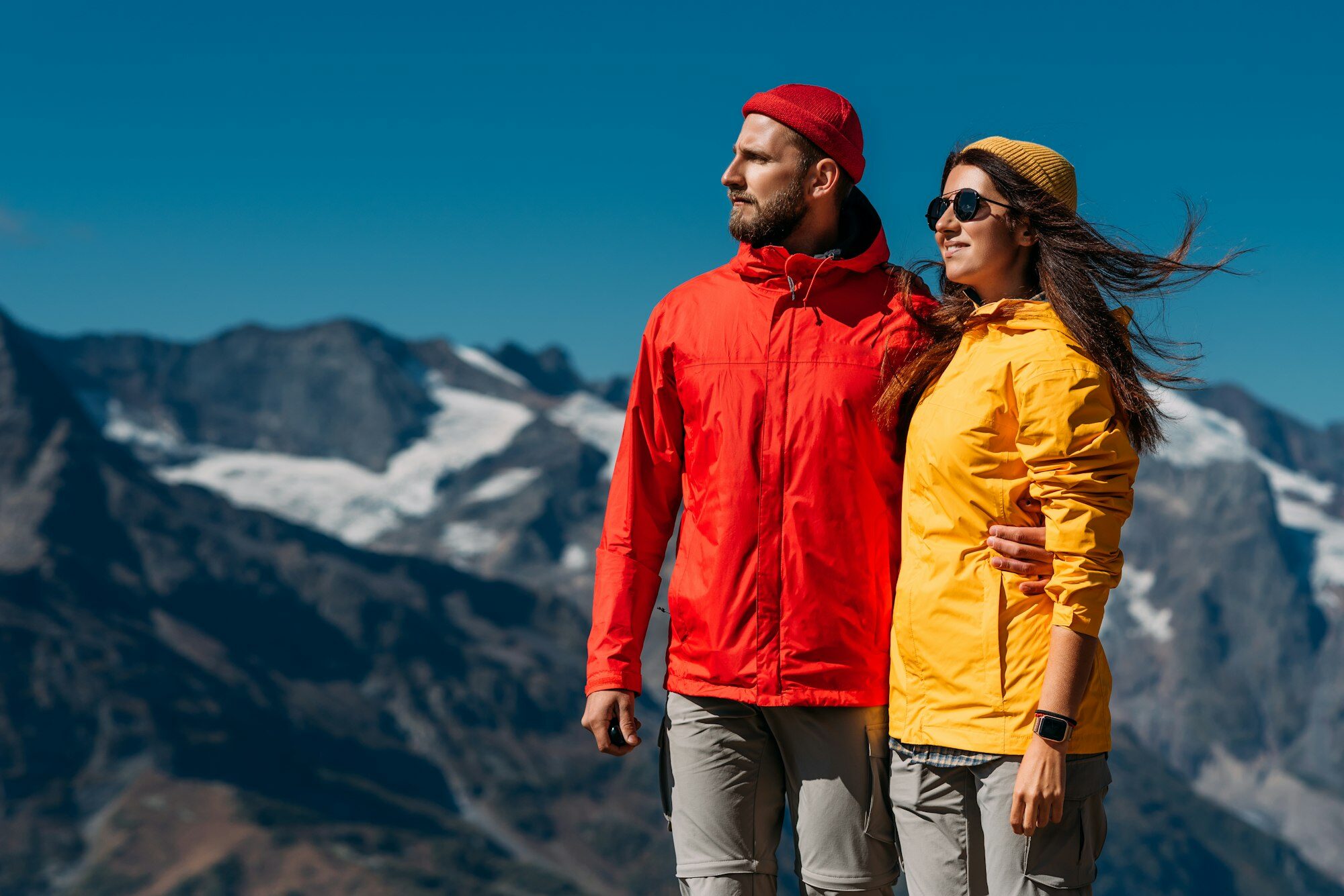 portrait-of-travelers-in-tourist-clothes-in-the-mountains-a-sporty-couple-on-top-of-a-mountain-e1705950375543.jpg